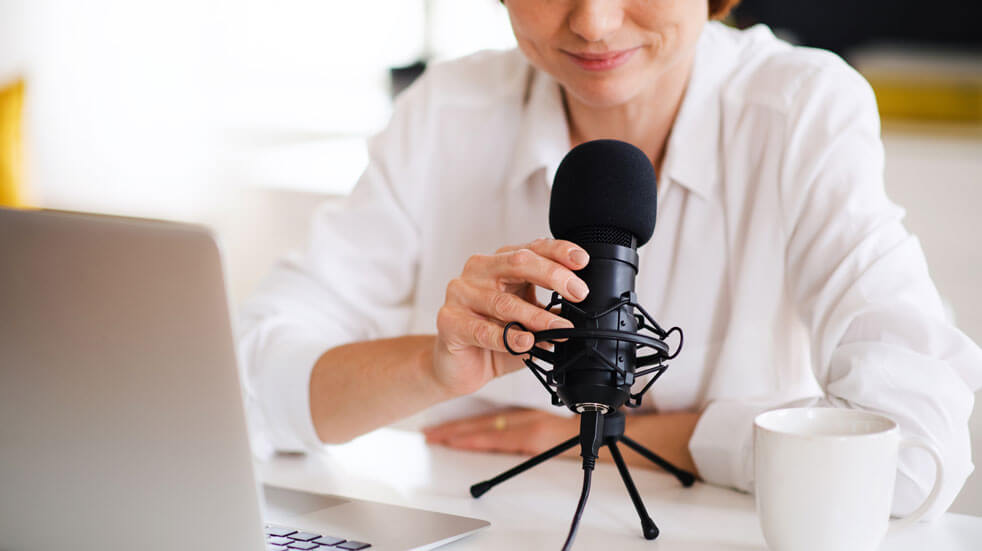 Everything you need to know about podcasts; woman recording podcasts